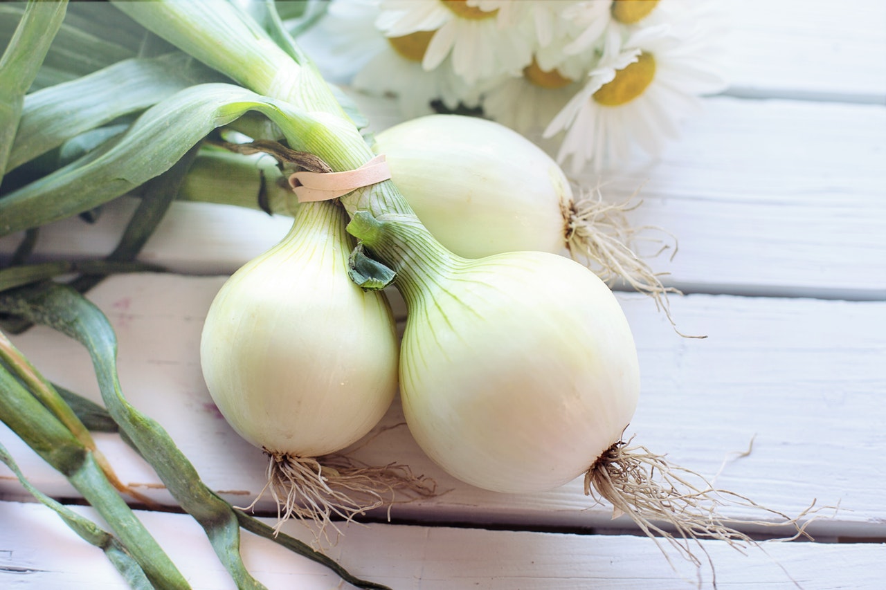 Onions placed on a white table