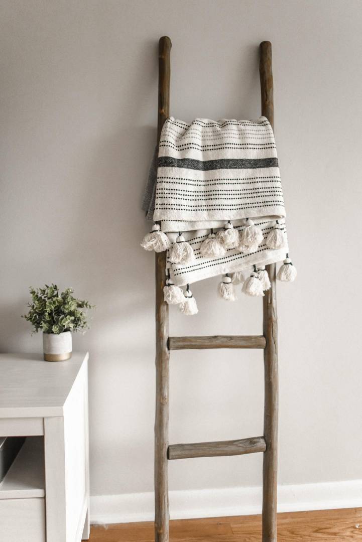 A small wooden ladder stands in the room